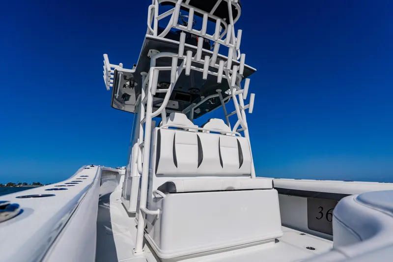 Slide: The Image of 2025 Yellowfin 36 Offshore boat with sleek white design under clear blue sky. - 39