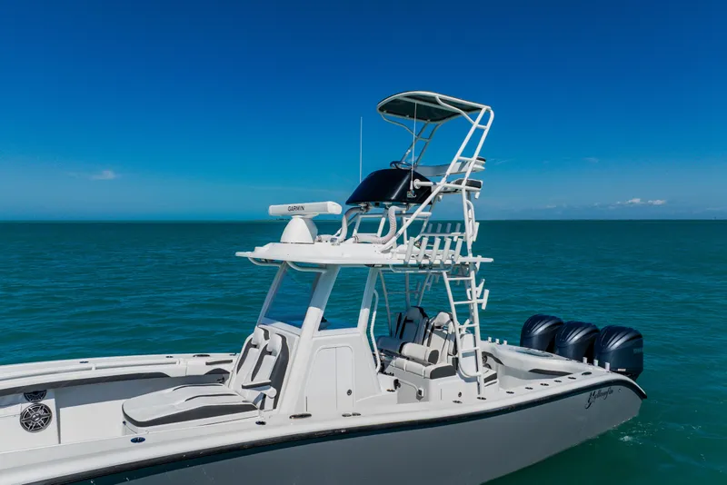 Slide: The Image of 2025 Yellowfin 36 Offshore boat on open sea with clear blue sky. - 4