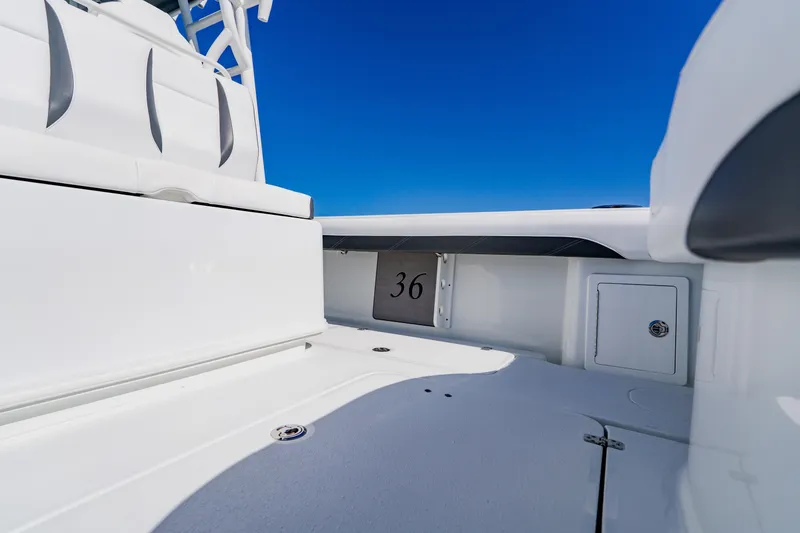 Slide: The Image of 2025 Yellowfin 36 Offshore boat interior with sleek white seating and clear blue sky. - 41