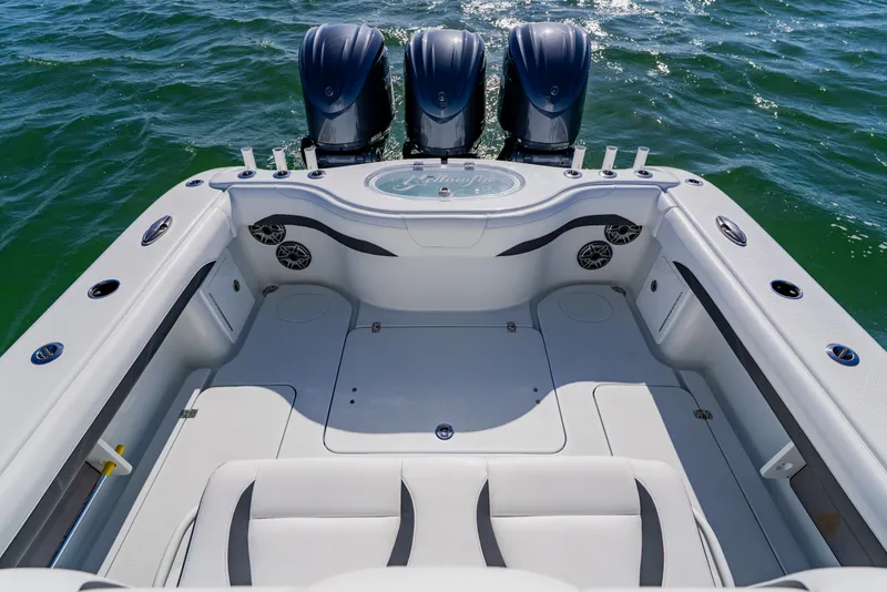 Slide: The Image of 2025 Yellowfin 36 Offshore boat deck with triple outboard engines on open water. - 43