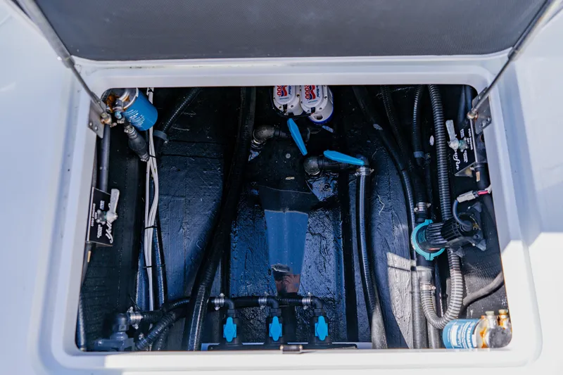 Slide: The Image of 2025 Yellowfin 36 Offshore boat engine compartment with visible wiring and components. - 46