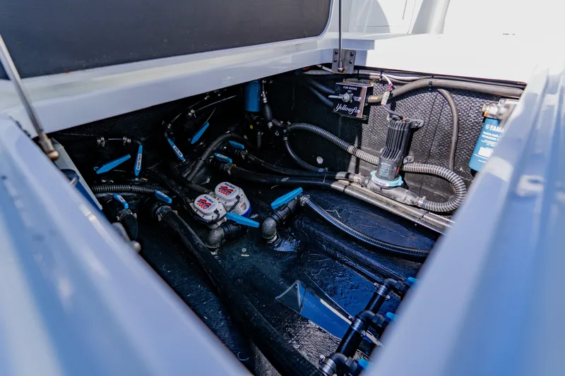 Slide: The Image of 2025 Yellowfin 36 Offshore boat engine compartment with visible wiring and components. - 48
