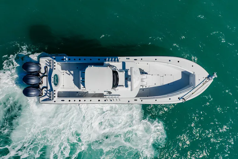 Slide: The Image of Aerial view of 2025 Yellowfin 36 Offshore boat cruising in turquoise waters. - 5