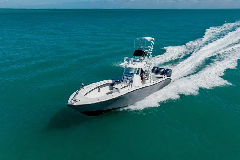 Slide: The Image of 2025 Yellowfin 36 Offshore boat cruising on clear blue ocean waters. - 6