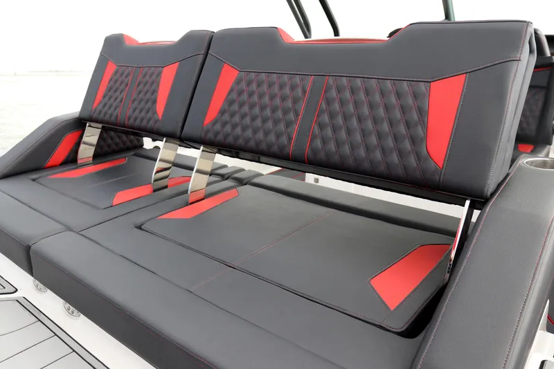 Slide: The Image of Luxury seating on 2026 Monterey Elite 30 OB boat, featuring black and red upholstery. - 2