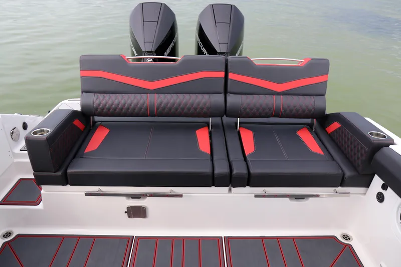Slide: The Image of 2026 Monterey Elite 30 OB boat with stylish black and red seating, dual engines visible. - 3