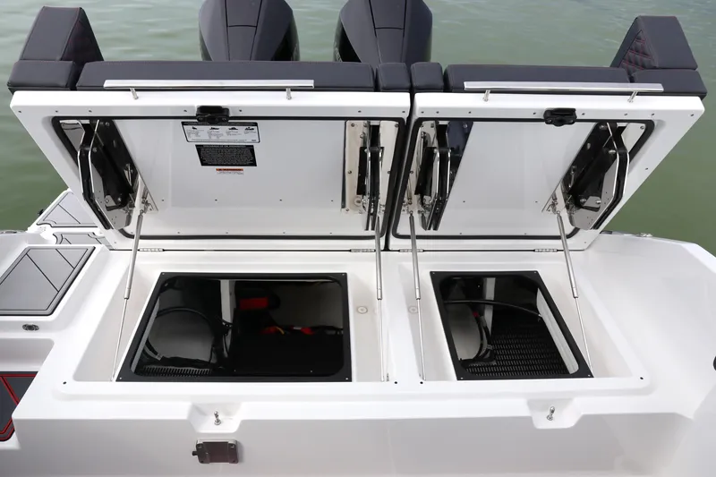 Slide: The Image of 2026 Monterey Elite 30 OB boat storage compartments open on the deck. - 4