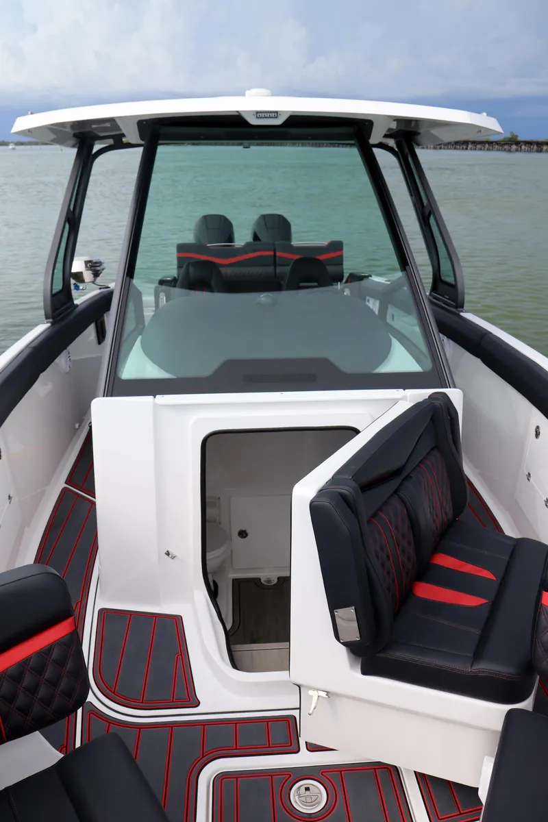 Slide: The Image of 2026 Monterey Elite 30 OB boat interior with modern seating and sleek design. - 9