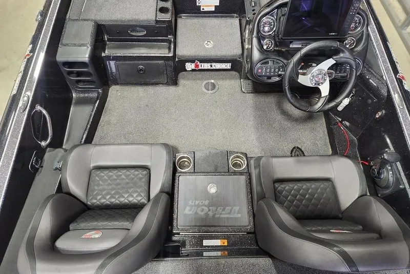 Slide: The Image of Interior of a 2019 Triton 21 TrX boat with dual seats and steering console. - 4
