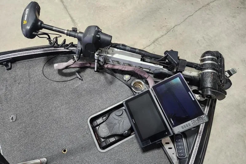 Slide: The Image of 2019 Triton 21 TrX boat with trolling motor and dual fish finders on deck. - 6