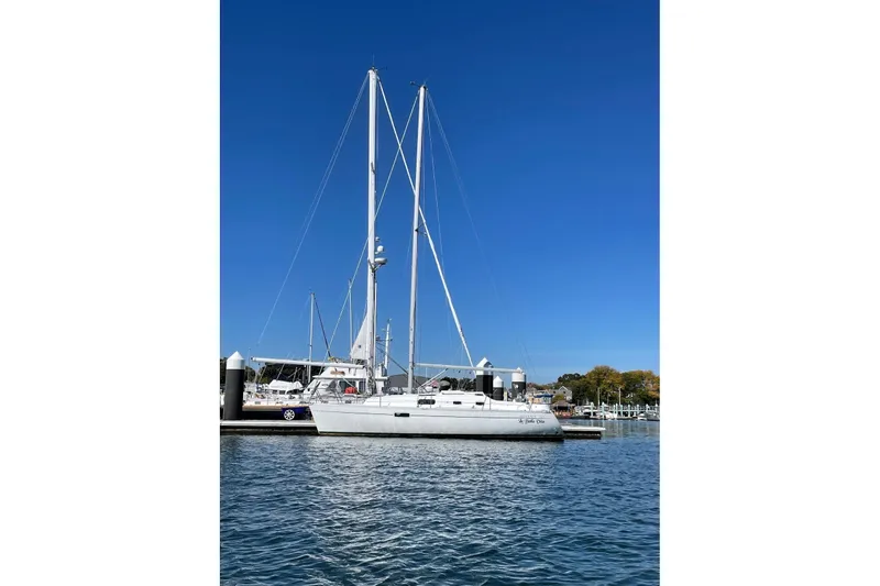 Slide: The Image of 1999 Beneteau Oceanis 321 sailboat docked in a marina under clear blue skies. - 14