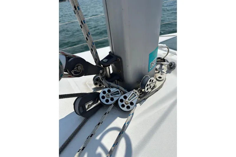 Slide: The Image of Close-up of Beneteau Oceanis 321 sailboat rigging, showcasing ropes and pulleys, 1999 model. - 17