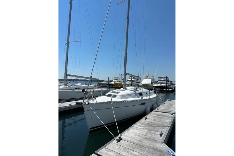 Slide: The Image of 1999 Beneteau Oceanis 321 sailboat docked at marina under clear blue sky. - 18