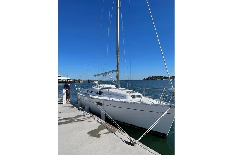 Slide: The Image of 1999 Beneteau Oceanis 321 sailboat docked at a marina under clear blue skies. - 19
