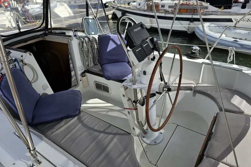 Slide: The Image of Cockpit of 1999 Beneteau Oceanis 321 sailboat with steering wheel and seating. - 5