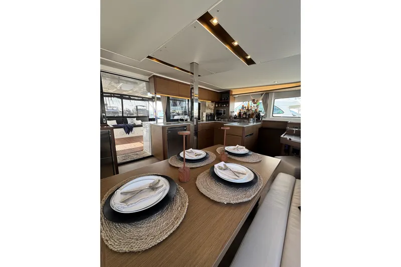 Slide: The Image of Luxurious interior of 2020 Lagoon 46 yacht with elegant dining setup. - 11