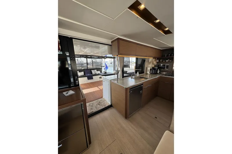 Slide: The Image of Modern kitchen interior of 2020 Lagoon 46 yacht with sleek wood cabinetry. - 12