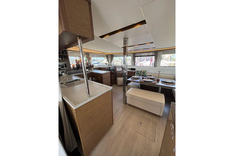 Slide: The Image of Interior of 2020 Lagoon 46 catamaran with modern kitchen and dining area. - 14