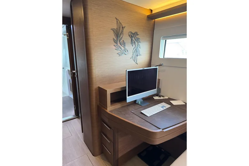 Slide: The Image of Modern workspace on 2020 Lagoon 46 yacht with computer and elegant wood finish. - 19