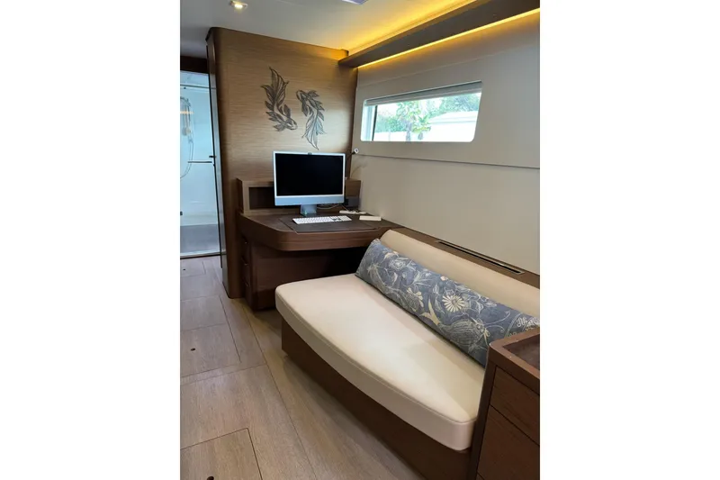Slide: The Image of Interior of 2020 Lagoon 46 yacht with desk, computer, and cushioned seating. - 21