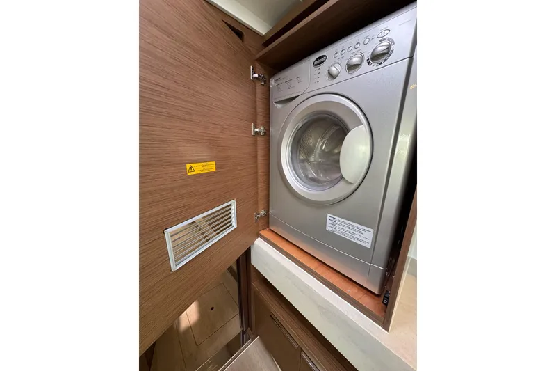 Slide: The Image of Washing machine inside a 2020 Lagoon 46 yacht's wooden cabinet. - 27