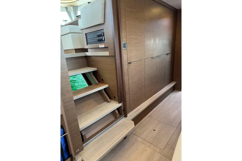 Slide: The Image of Interior of 2020 Lagoon 46 yacht featuring wooden stairs and modern paneling. - 28