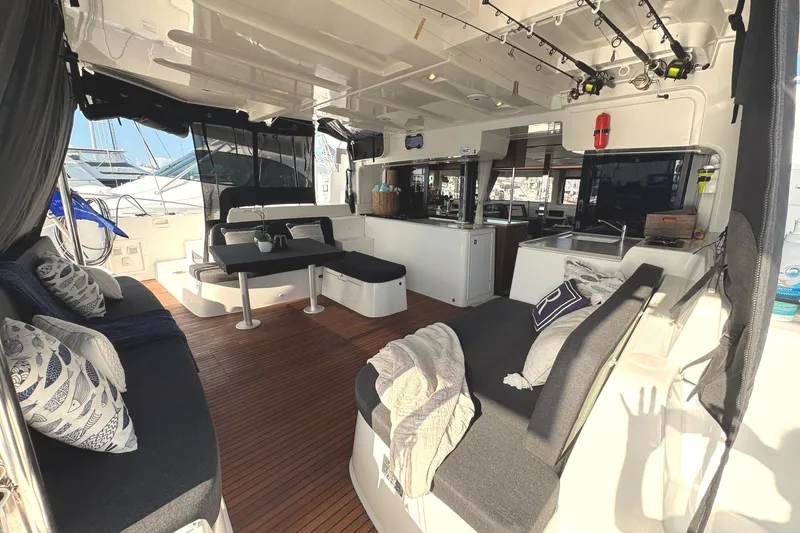 Slide: The Image of Luxurious 2020 Lagoon 46 yacht interior with seating, dining area, and fishing rods. - 3