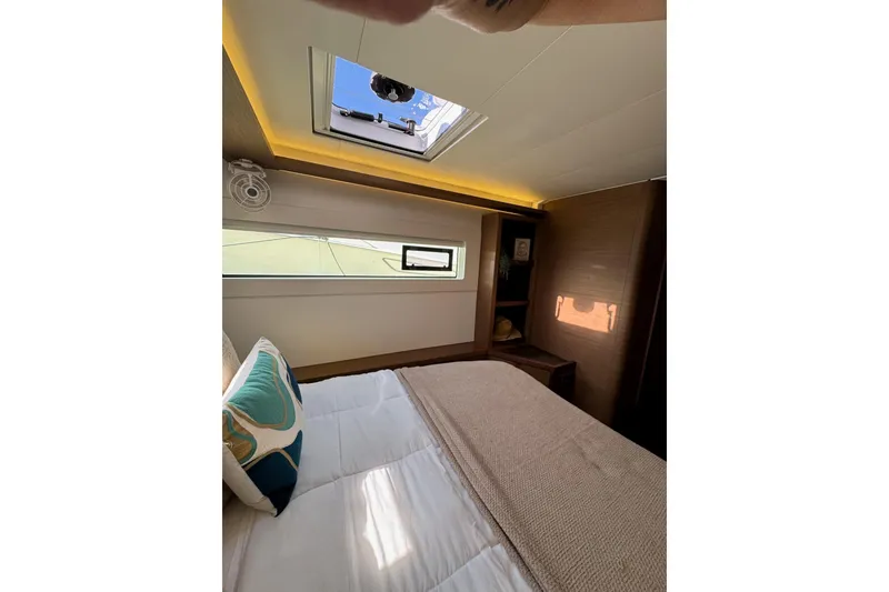 Slide: The Image of Luxurious cabin interior of 2020 Lagoon 46 catamaran with skylight and cozy bedding. - 31