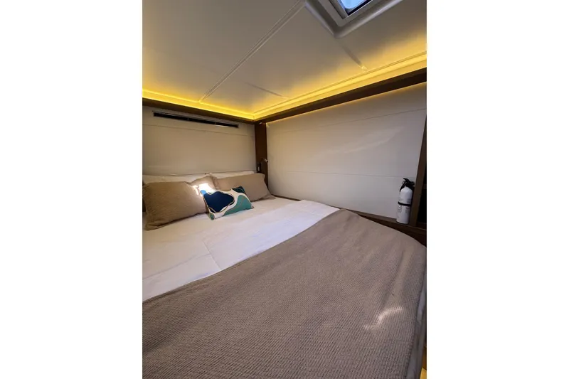 Slide: The Image of Luxurious cabin interior of 2020 Lagoon 46 yacht with cozy bedding and ambient lighting. - 36
