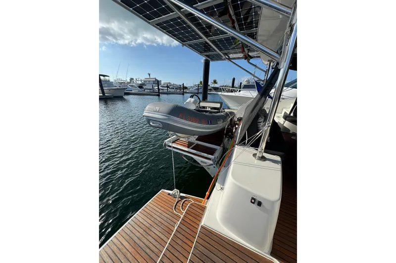 Slide: The Image of 2020 Lagoon 46 yacht with solar panels and dinghy at marina. - 44