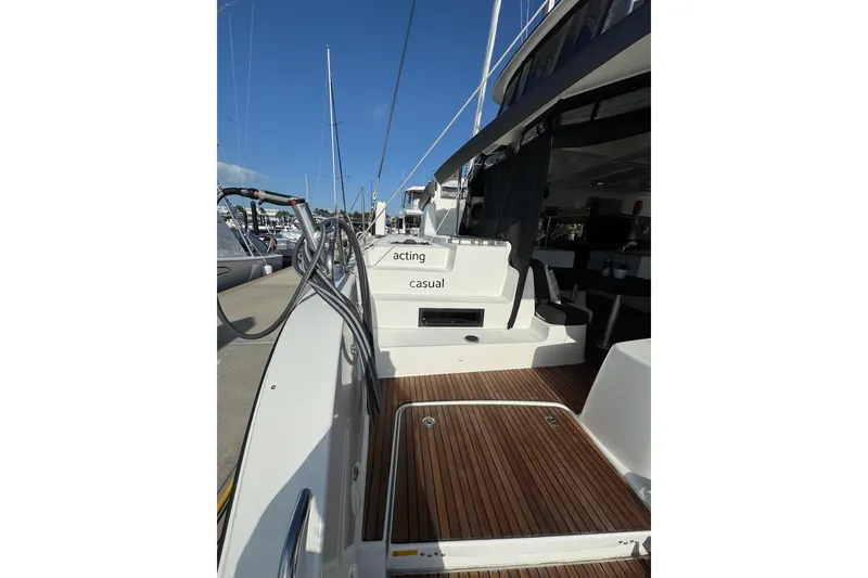 Slide: The Image of 2020 Lagoon 46 yacht with teak deck and marina view. - 46