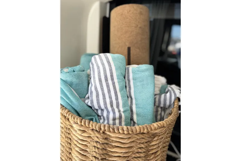 Slide: The Image of Woven basket with striped and teal towels on Lagoon 46 yacht, 2020 model. - 49