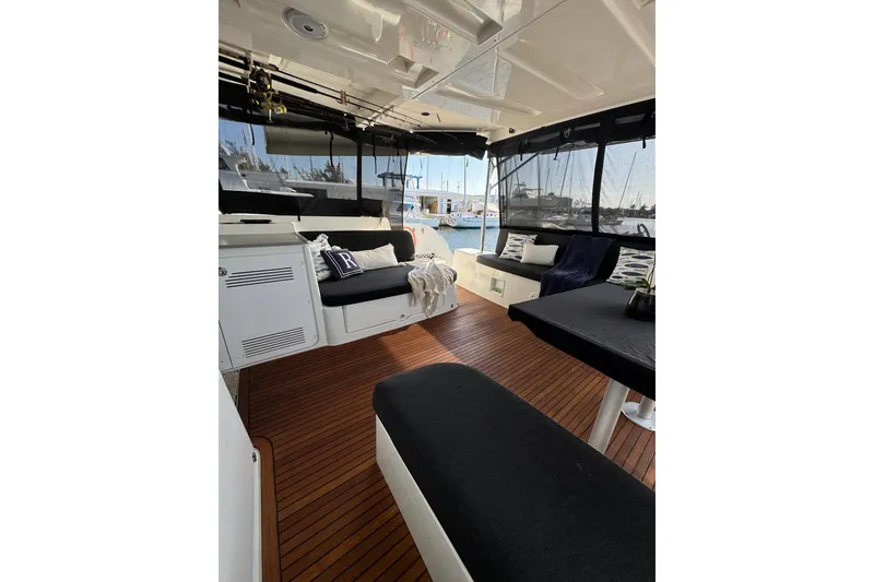Slide: The Image of Interior of 2020 Lagoon 46 catamaran with wooden flooring and comfortable seating. - 5