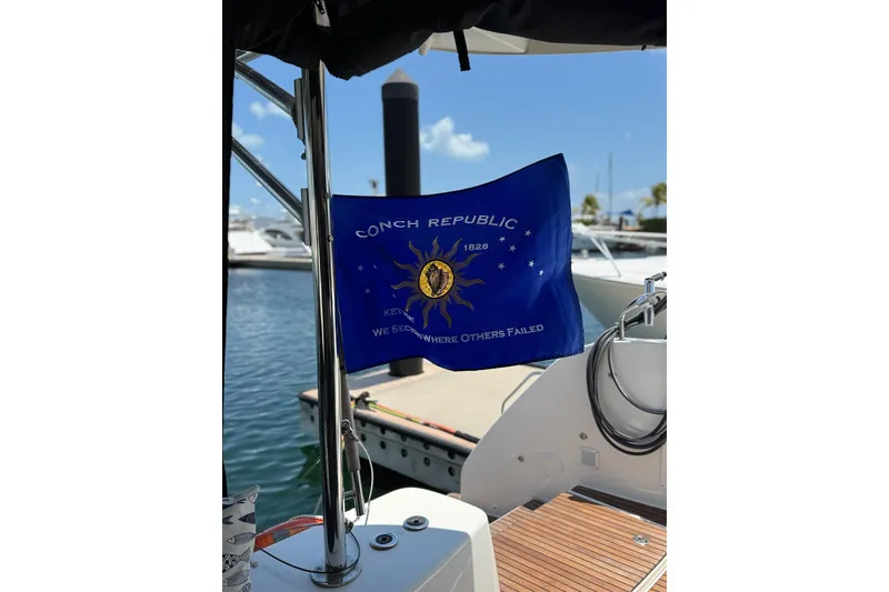 Slide: The Image of Lagoon 46 (2020) yacht with Conch Republic flag in marina setting. - 50