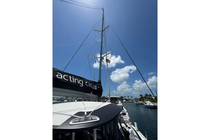 Slide: The Image of 2020 Lagoon 46 catamaran docked under clear blue sky. - 56