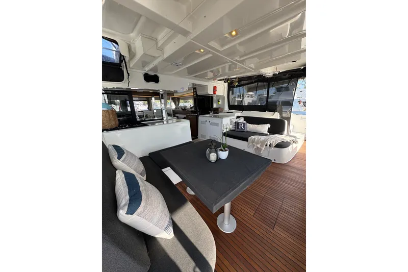 Slide: The Image of Luxurious interior of 2020 Lagoon 46 yacht with modern seating and dining area. - 6