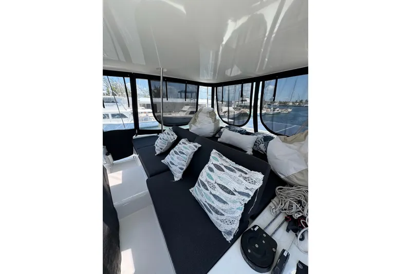 Slide: The Image of Luxurious interior of 2020 Lagoon 46 catamaran with plush seating and decorative pillows. - 61