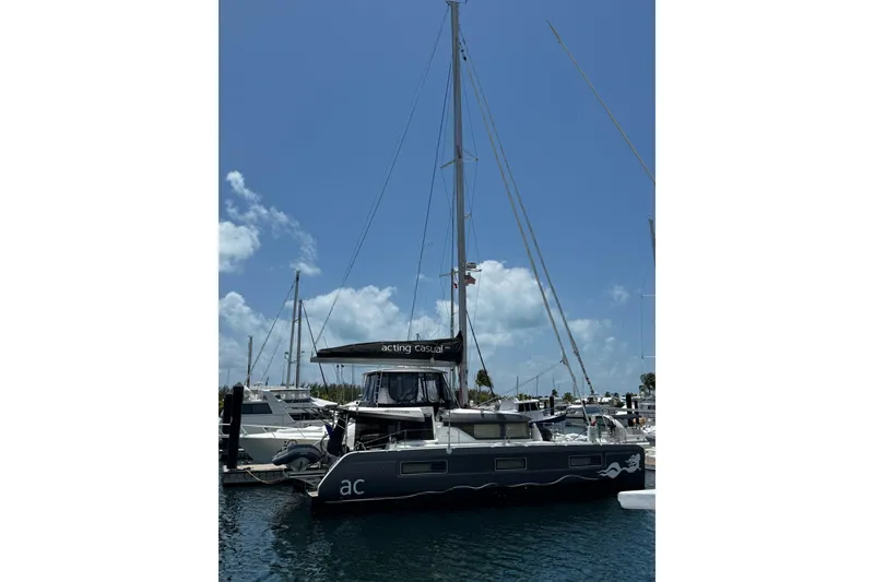Slide: The Image of 2020 Lagoon 46 catamaran docked at marina under clear blue sky. - 63