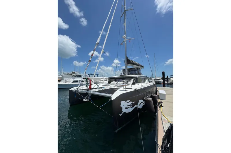 Slide: The Image of 2020 Lagoon 46 catamaran docked under a clear blue sky. - 66