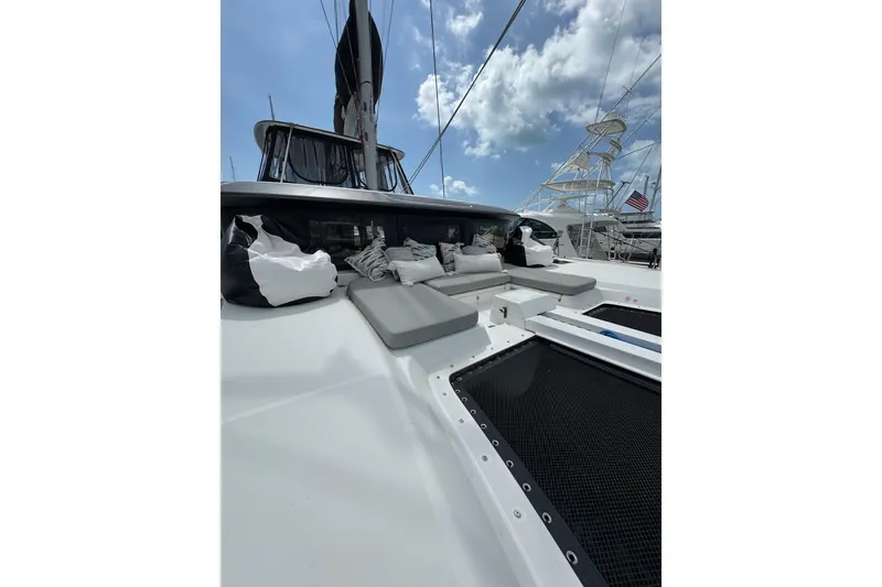 Slide: The Image of 2020 Lagoon 46 catamaran deck with cushions under a blue sky. - 77