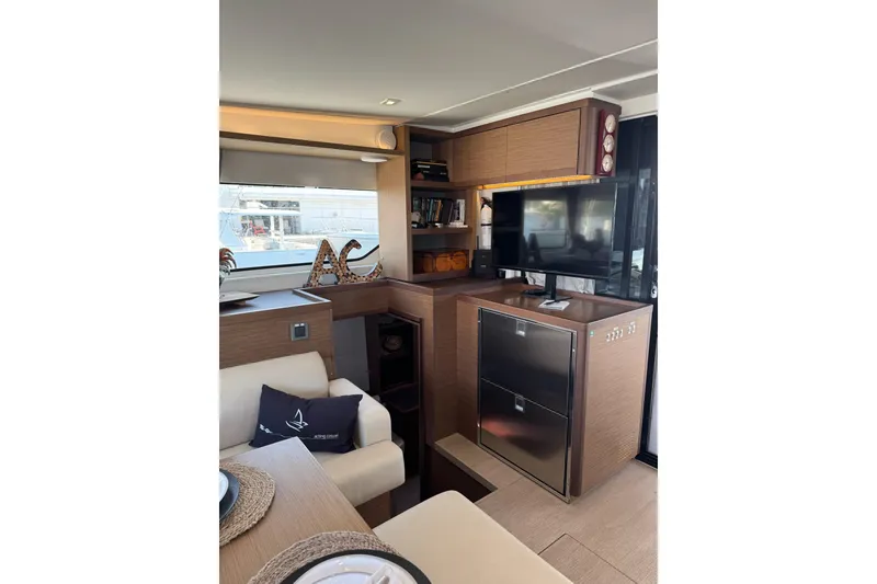 Slide: The Image of Interior of 2020 Lagoon 46 yacht with modern furnishings and entertainment setup. - 8