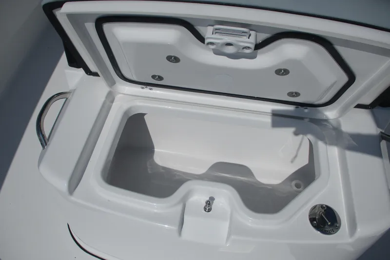 Slide: The Image of 2026 Sportsman Open 252 Center Console storage compartment, open lid, white interior. - 15
