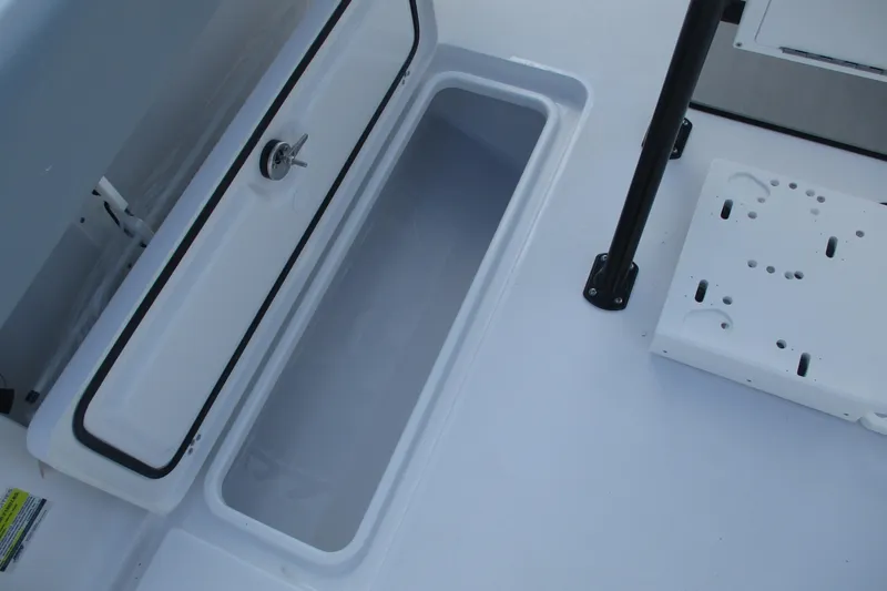 Slide: The Image of 2026 Sportsman Open 252 Center Console storage compartment, open lid, white interior. - 17