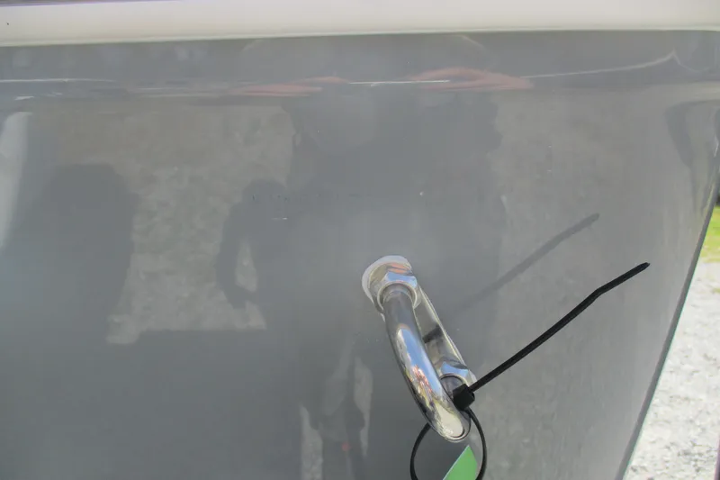 Slide: The Image of 2026 Sportsman Open 252 Center Console boat detail with metal cleat and zip tie. - 24