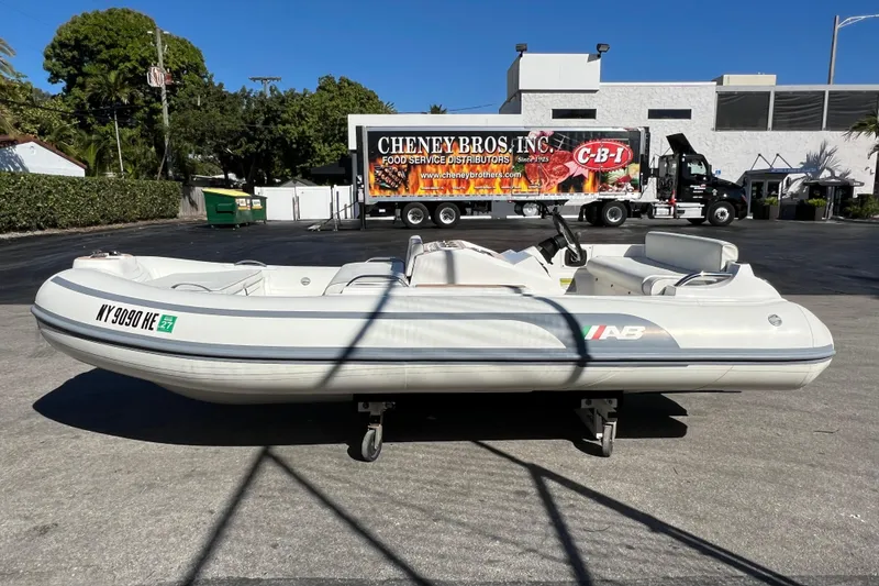 Slide: The Image of 2021 AB Inflatables ABJET 380 boat on pavement, with a truck in the background. - 2