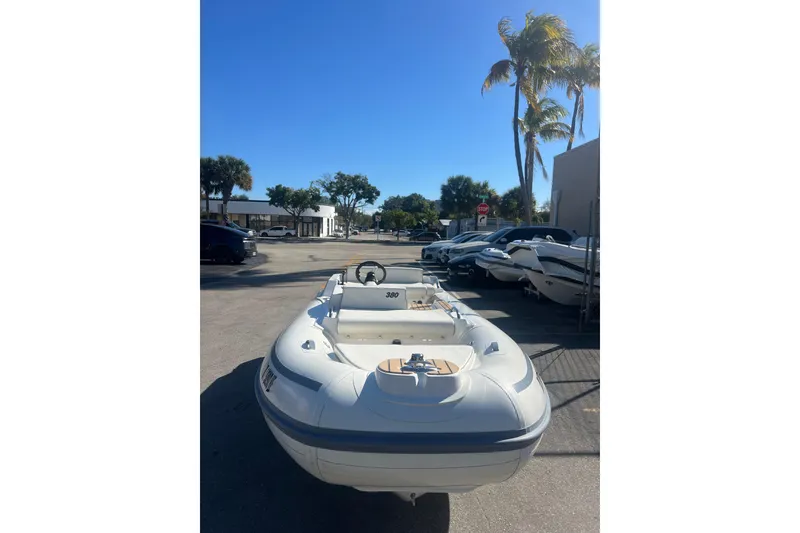 Slide: The Image of 2021 AB Inflatables ABJET 380 boat parked outdoors under clear blue sky. - 4