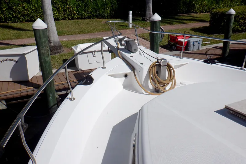 Slide: The Image of 2002 Mainship 430 Trawler docked, featuring deck and railing details. - 10