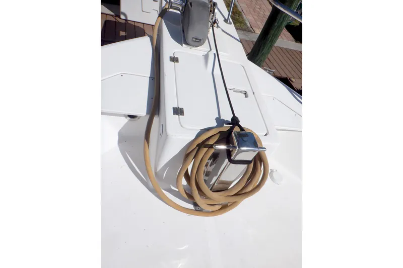Slide: The Image of 2002 Mainship 430 Trawler deck with coiled hose and storage compartment. - 12