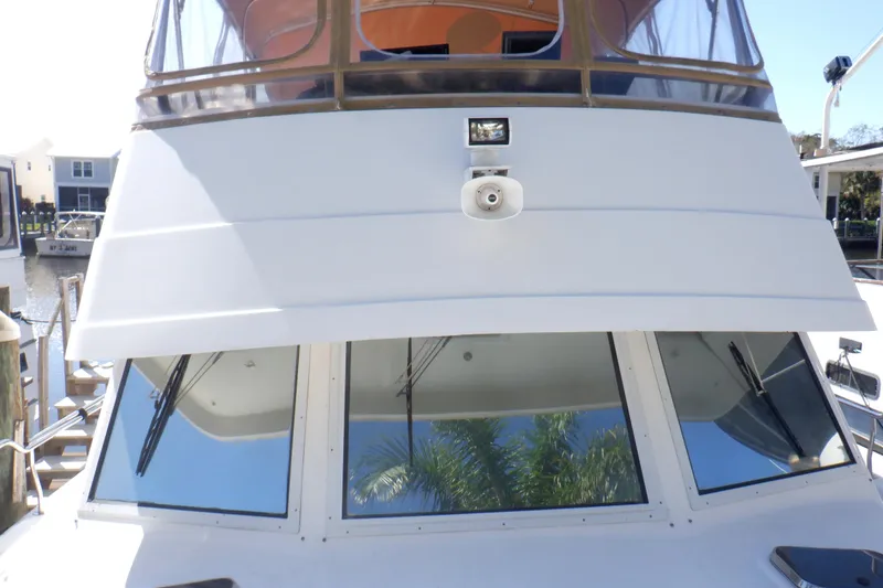 Slide: The Image of 2002 Mainship 430 Trawler front view with windows and deck details. - 14