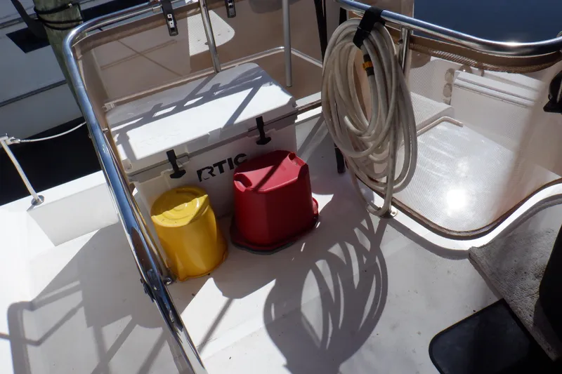 Slide: The Image of 2002 Mainship 430 Trawler deck with cooler, buckets, and coiled hose. - 17